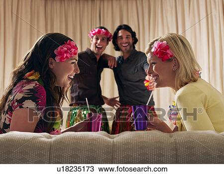 Stock Image - Two couples at dressing up party. Fotosearch