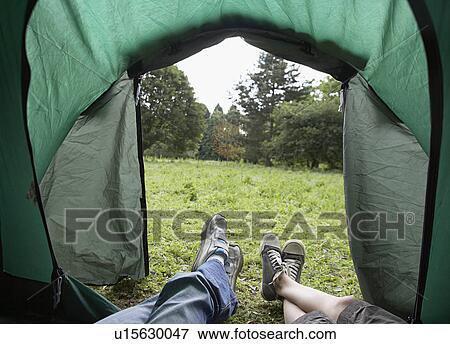 Two girls (7-9) lying in tent low section View Large Photo Image Stock Photo - Two girls (7-9) lying in tent low section. Fotosearch