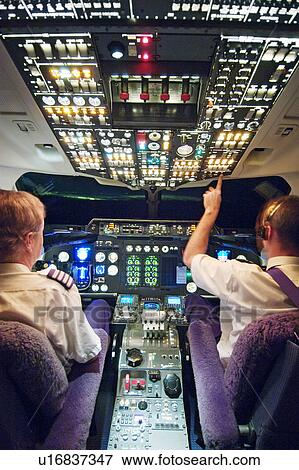 Stock Photo - Two pilots in aeroplane cockpit. Fotosearch