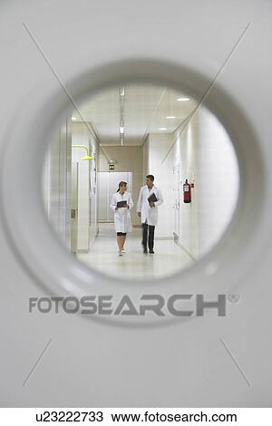 Two scientists walking down hallway view from window in door View Large Photo Image Stock Image - Two scientists walking down hallway view from window in door. Fotosearch