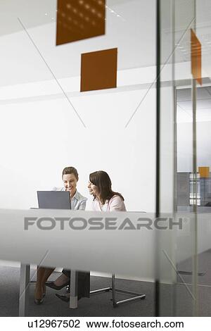 Two women in office View Large Photo Image Stock Image - Two women in office. Fotosearch