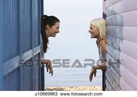 Two women leaning on beach house verandahs side view View Large Photo Image Stock Image - Two women leaning on beach house verandahs side view. Fotosearch