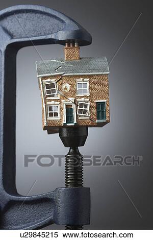 Vice gripping small model house View Large Photo Image Stock Photography - Vice gripping small model house. Fotosearch