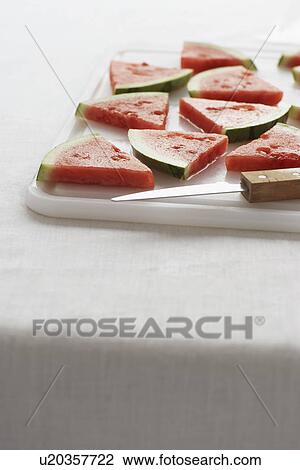 Watermelon slices on chopping board close-up View Large Photo Image Stock Image - Watermelon slices on chopping board close-up. Fotosearch