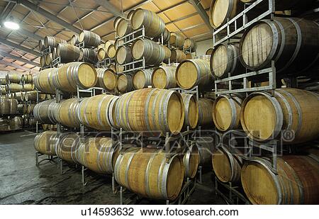 Stock Image - Wine barrels in storage shed. Fotosearch