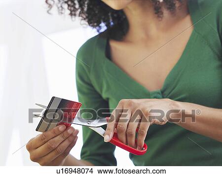 Woman cutting credit card low angle view mid section View Large Photo Image Picture - Woman cutting credit card low angle view mid section. Fotosearch