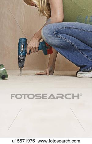Woman drilling floor low section View Large Photo Image Stock Photograph - Woman drilling floor low section. Fotosearch