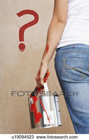 Woman holding painting can facing wall with painted question mark mid section back view View Large Photo Image Stock Image - Woman holding painting can facing wall with painted question mark mid section back view. Fotosearch