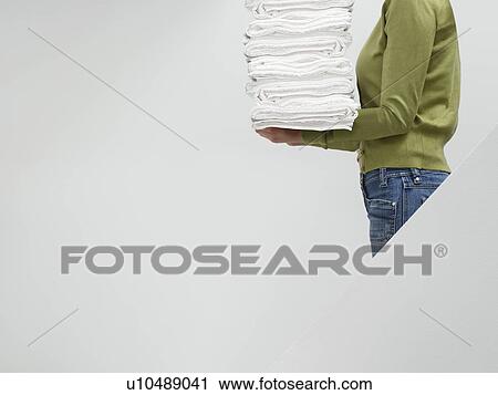 Woman holding stack of fresh towels on stairs side view mid section View Large Photo Image Stock Image - Woman holding stack of fresh towels on stairs side view mid section. Fotosearch