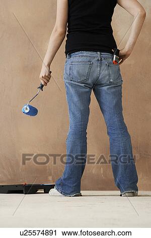 Woman painting wall with paint roller low section back view View Large Photo Image Stock Image - Woman painting wall with paint roller low section back view. Fotosearch