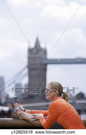 Woman stretching in front of Tower Bridge England London View Large Photo Image Stock Photo - Woman stretching in front of Tower Bridge England London. Fotosearch