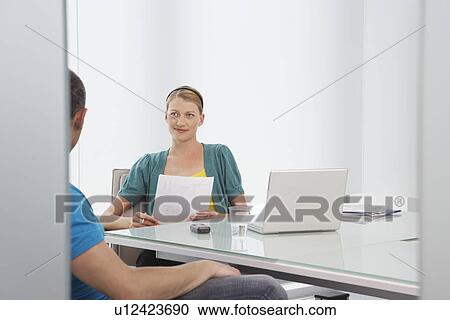 Woman talking to man in office View Large Photo Image Stock Image - Woman talking to man in office. Fotosearch