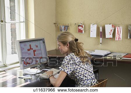 Woman using computer in office View Large Photo Image Stock Photograph - Woman using computer in office. Fotosearch