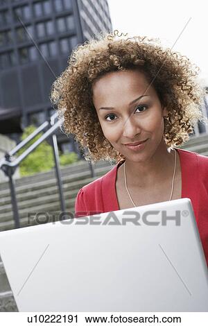 Woman using laptop on steps portrait View Large Photo Image Stock Image - Woman using laptop on steps portrait. Fotosearch