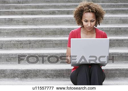 Woman using laptop on steps View Large Photo Image Stock Photo - Woman using laptop on steps. Fotosearch