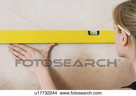 Woman using spirit level close-up View Large Photo Image Picture - Woman using spirit level close-up. Fotosearch