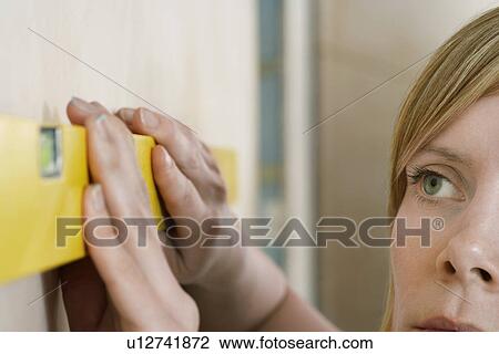 Woman using spirit level close-up View Large Photo Image Stock Image - Woman using spirit level close-up. Fotosearch