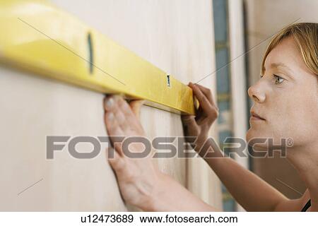 Woman using spirit level close-up View Large Photo Image Stock Photo - Woman using spirit level close-up. Fotosearch