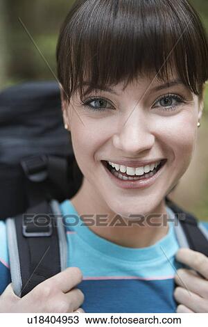 Stock Image - Woman wearing backpack close-up portrait. Fotosearch