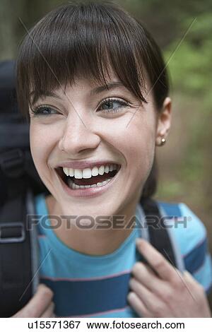 Woman wearing backpack smiling close-up View Large Photo Image Stock Photo - Woman wearing backpack smiling close-up. Fotosearch