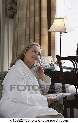 Woman wearing bathrobe using phone in living room portait View Large Photo Image Stock Photography - Woman wearing bathrobe using phone in living room portait. Fotosearch