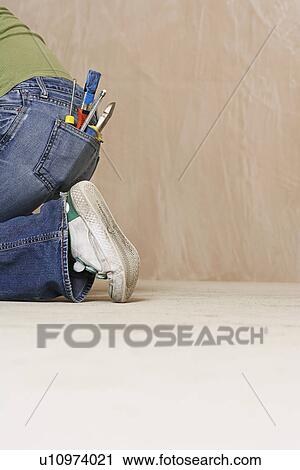 Woman with paintbrush and hand tools in back jeans pocket kneeling on floor low section View Large Photo Image Stock Image - Woman with paintbrush and hand tools in back jeans pocket kneeling on floor low section. Fotosearch