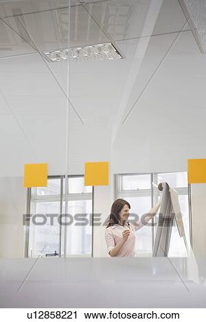 Woman working in office at presentation board side view View Large Photo Image Stock Image - Woman working in office at presentation board side view. Fotosearch