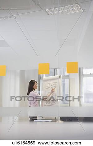 Woman working in office at presentation board side view View Large Photo Image Stock Photo - Woman working in office at presentation board side view. Fotosearch