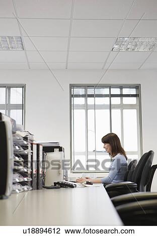 Woman working in office side view View Large Photo Image Stock Image - Woman working in office side view. Fotosearch