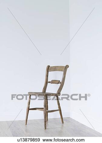 Stock Photo - Wooden chair in empty room corner. Fotosearch