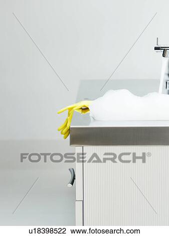 Yellow rubber gloves on edge of sink View Large Photo Image Stock Image - Yellow rubber gloves on edge of sink. Fotosearch