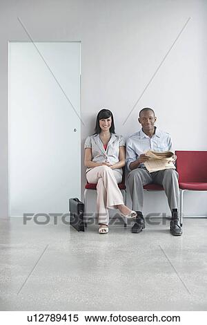Young man and woman waiting on chairs in corridor portrait View Large Photo Image Stock Photography - Young man and woman waiting on chairs in corridor portrait. Fotosearch