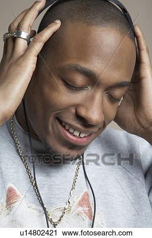 Young man with head in hands close-up View Large Photo Image Stock Image - Young man with head in hands close-up. Fotosearch