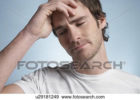 Stock Photo - Young man with headache portrait. Fotosearch