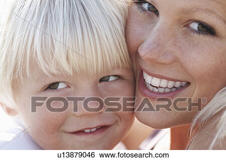 Stock Photograph - Young mother and son (3-4) close-up son looking away. Fotosearch
