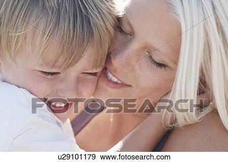 Young mother kissing son (3-4) close-up View Large Photo Image Stock Photo - Young mother kissing son (3-4) close-up. Fotosearch