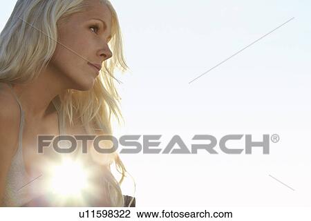 Young woman against sun close up low angle view View Large Photo Image Stock Image - Young woman against sun close up low angle view. Fotosearch