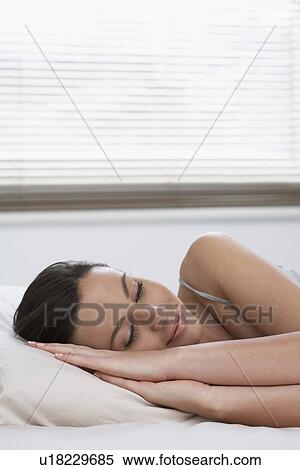 Young woman asleep in bed smiling View Large Photo Image Stock Photography - Young woman asleep in bed smiling. Fotosearch