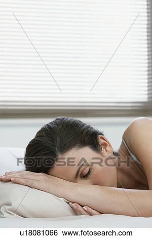 Young woman asleep in bed View Large Photo Image Stock Photograph - Young woman asleep in bed. Fotosearch