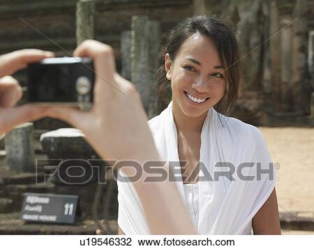 Young woman at street posing to photograph selective focus View Large Photo Image Stock Image - Young woman at street posing to photograph selective focus. Fotosearch