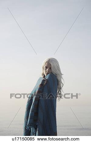 Young woman covered with blanket on beach portrait View Large Photo Image Stock Photography - Young woman covered with blanket on beach portrait. Fotosearch