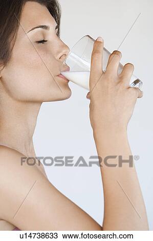 Young woman drinking milk side view View Large Photo Image Stock Image - Young woman drinking milk side view. Fotosearch
