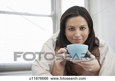 Young woman drinking tea in bed portrait View Large Photo Image Stock Photograph - Young woman drinking tea in bed portrait. Fotosearch