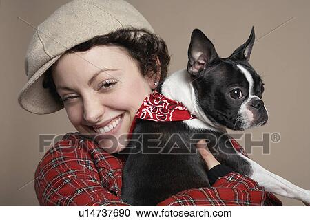 Young woman holding French Bulldog close-up View Large Photo Image Stock Image - Young woman holding French Bulldog close-up. Fotosearch