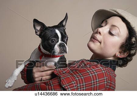 Stock Photograph - Young woman holding French Bulldog. Fotosearch
