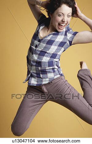 Young woman jumping and screaming View Large Photo Image Picture - Young woman jumping and screaming. Fotosearch