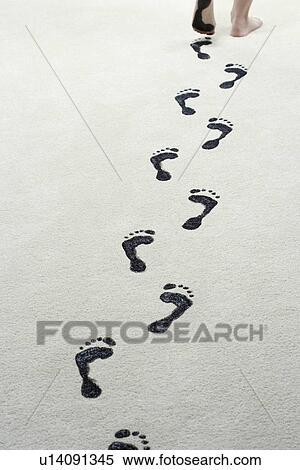 Young woman leaving black footprints on carpet View Large Photo Image Stock Photography - Young woman leaving black footprints on carpet. Fotosearch
