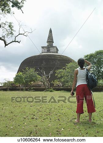 Young woman looking at stupa back view View Large Photo Image Picture - Young woman looking at stupa back view. Fotosearch