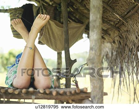 Young woman lying in hut legs crossed back view low section View Large Photo Image Stock Photography - Young woman lying in hut legs crossed back view low section. Fotosearch