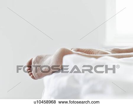 Young woman lying on bed close-up of feet View Large Photo Image Stock Photo - Young woman lying on bed close-up of feet. Fotosearch